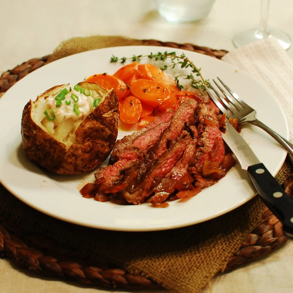 three pepper flank stead with red onions