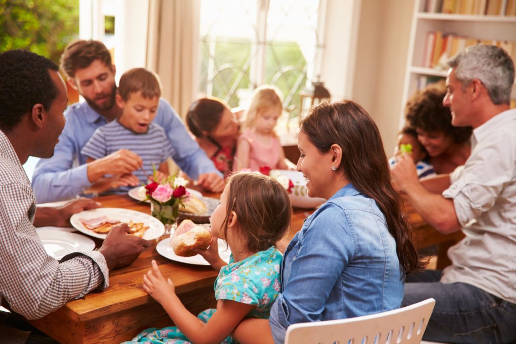 large group sharing a meal: why eating together is important