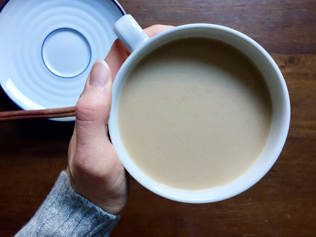 mug of homemade chai in hand