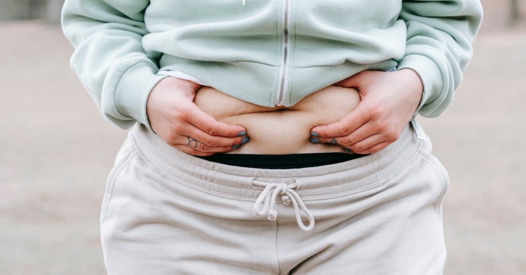 how to reduce bloating during perimenopause: woman showing folds of stomach