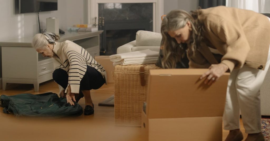 Cleaning out a parent's house: Two women packing belongings in boxes