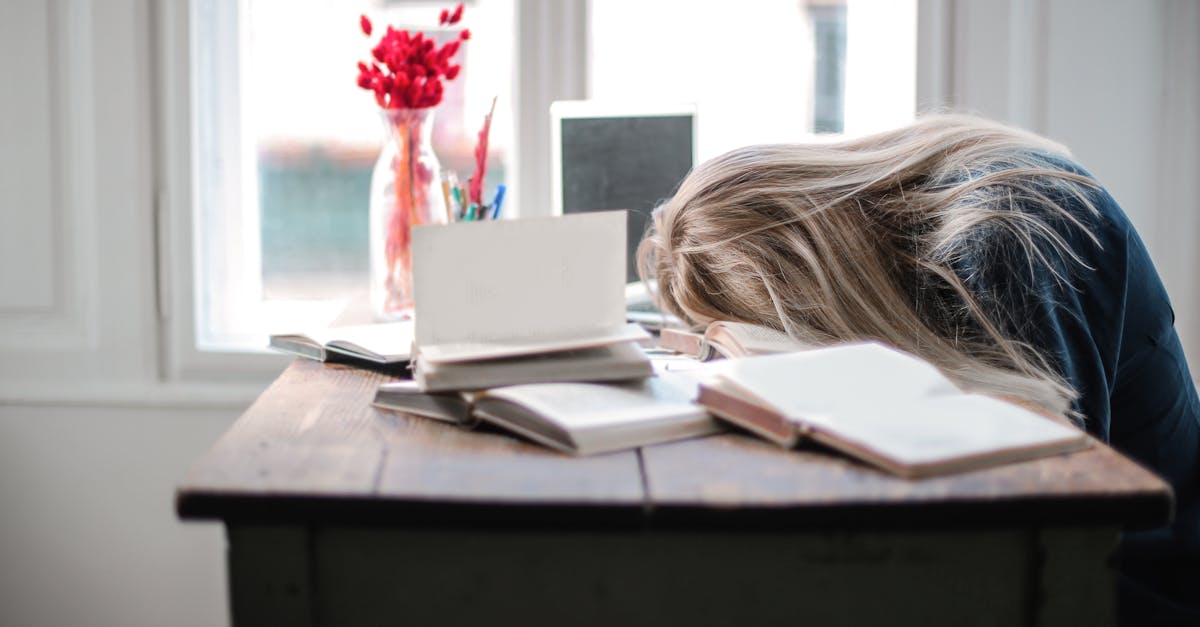 woman slumped over desk feeling exhausted: how to overcome burnout, rediscover motivation, and get back on track.